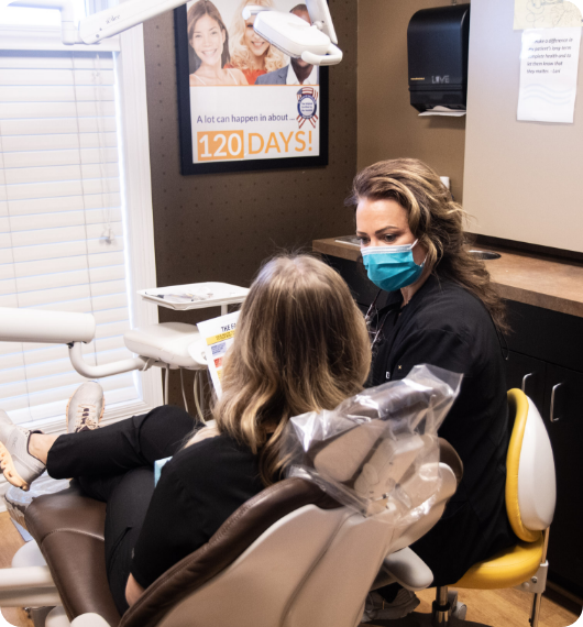 woman holding clear aligners